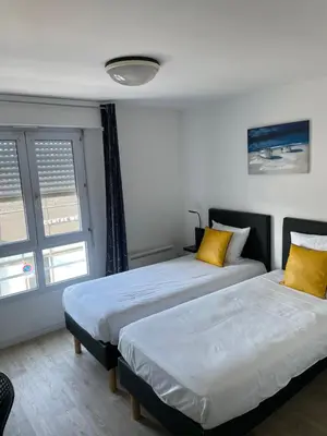 Un ou plusieurs lits dans un hébergement de l'établissement Brit Hotel Cherbourg