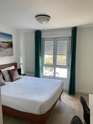 Un ou plusieurs lits dans un hébergement de l'établissement Brit Hotel Cherbourg