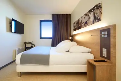 Un ou plusieurs lits dans un hébergement de l'établissement Kyriad Prestige Residence & Spa Cabourg-Dives-sur-Mer