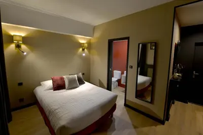 Un ou plusieurs lits dans un hébergement de l'établissement Hôtel Le Tiburon
