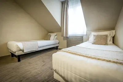 Un ou plusieurs lits dans un hébergement de l'établissement Hôtel De Brunville & Spa