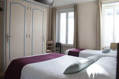 Un ou plusieurs lits dans un hébergement de l'établissement Cit'Hotel Hôtel Beauséjour