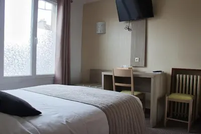 Un ou plusieurs lits dans un hébergement de l'établissement Cit'Hotel Hôtel Beauséjour