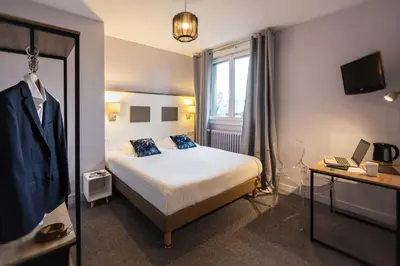 Un ou plusieurs lits dans un hébergement de l'établissement Hôtel du Musée
