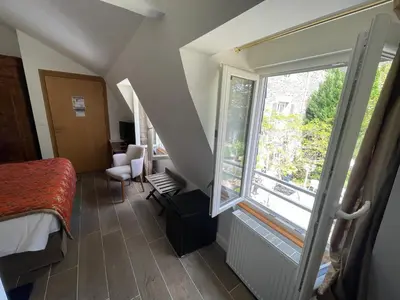 Un ou plusieurs lits dans un hébergement de l'établissement Hôtel Victor Hugo