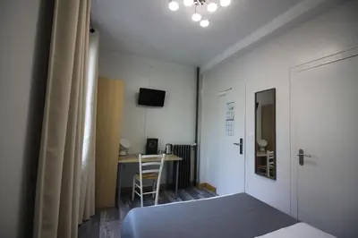Un ou plusieurs lits dans un hébergement de l'établissement Hotel De l'Univers