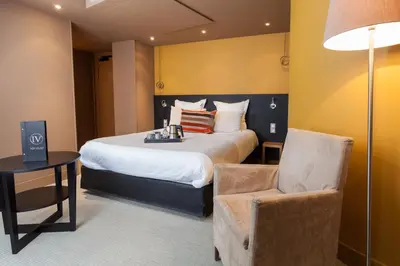 Un ou plusieurs lits dans un hébergement de l'établissement Hotel Restaurant Spa Ivan Vautier