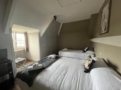 Un ou plusieurs lits dans un hébergement de l'établissement Hôtel Le Phare