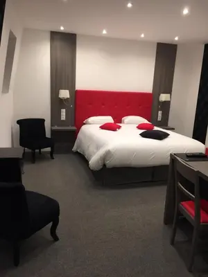 Un ou plusieurs lits dans un hébergement de l'établissement Le Beverl'inn