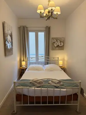 Un ou plusieurs lits dans un hébergement de l'établissement Fenêtres sur Mer Arromanches