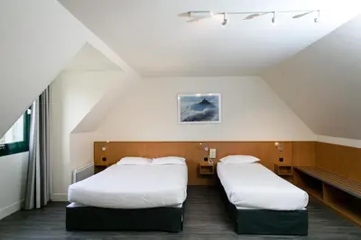 Un ou plusieurs lits dans un hébergement de l'établissement Hôtel Vert