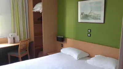 Un ou plusieurs lits dans un hébergement de l'établissement Hôtel Vert