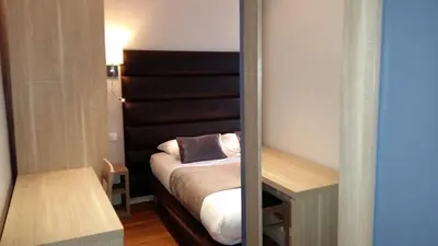 Un ou plusieurs lits dans un hébergement de l'établissement Hotel Napoléon