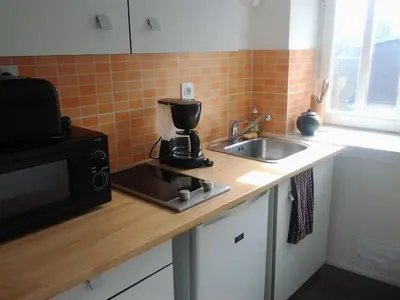 Cuisine ou kitchenette dans l'établissement Appartement Rue Georges V - Port de la Houle