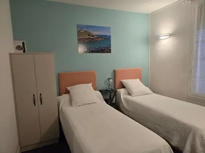 Un ou plusieurs lits dans un hébergement de l'établissement Hotel le Saint Germain