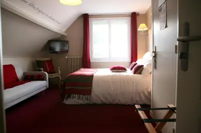 Un ou plusieurs lits dans un hébergement de l'établissement Cit'Hotel La Villa Julia