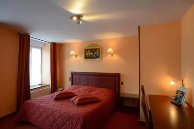 Un ou plusieurs lits dans un hébergement de l'établissement Hôtel de La Croix d'Or