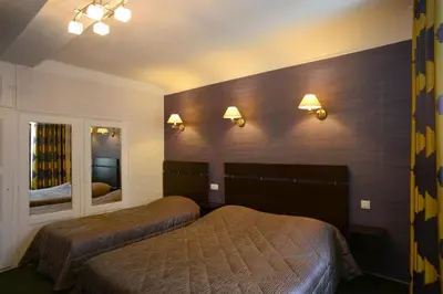 Un ou plusieurs lits dans un hébergement de l'établissement Hôtel de La Croix d'Or