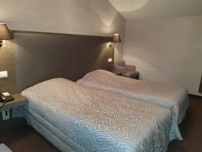 Un ou plusieurs lits dans un hébergement de l'établissement Hôtel de La Croix d'Or