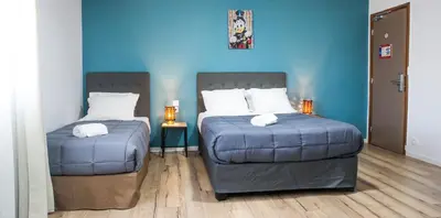 Un ou plusieurs lits dans un hébergement de l'établissement Hôtel Les Pieux En Cotentin