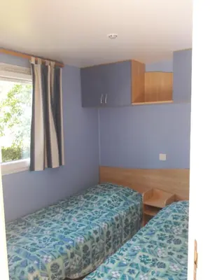 Un ou plusieurs lits dans un hébergement de l'établissement Camping le Balcon de la Baie