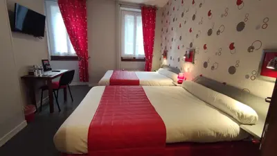 Un ou plusieurs lits dans un hébergement de l'établissement Hotel Angleterre