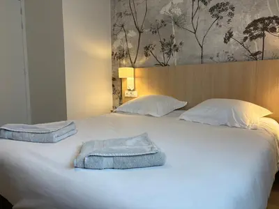 Un ou plusieurs lits dans un hébergement de l'établissement Hôtel Beaurivage
