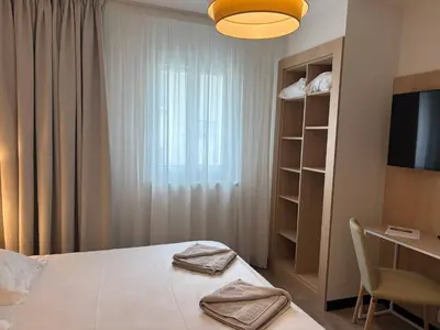 Un ou plusieurs lits dans un hébergement de l'établissement Hôtel Beaurivage