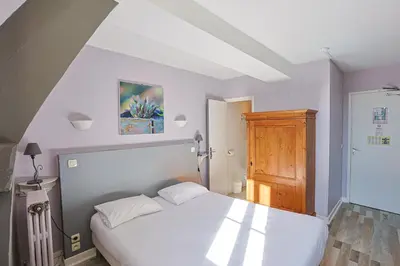 Un ou plusieurs lits dans un hébergement de l'établissement Hôtel François d'O