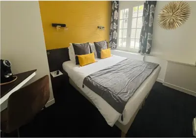 Un ou plusieurs lits dans un hébergement de l'établissement Hotel Reine Mathilde