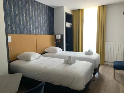 Un ou plusieurs lits dans un hébergement de l'établissement Hotel Le Cosy Riva Bella