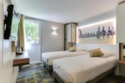 Un ou plusieurs lits dans un hébergement de l'établissement Brit Hotel Caen Nord - Mémorial