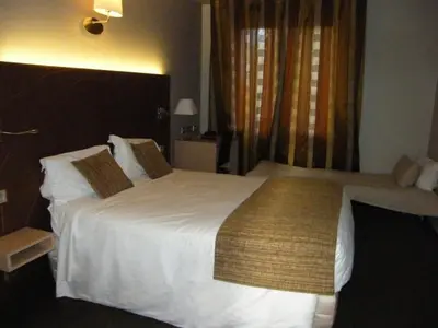 Un ou plusieurs lits dans un hébergement de l'établissement CIT'HOTEL Saint-Pierre