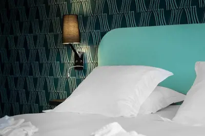 Un ou plusieurs lits dans un hébergement de l'établissement Zenith Hotel Caen