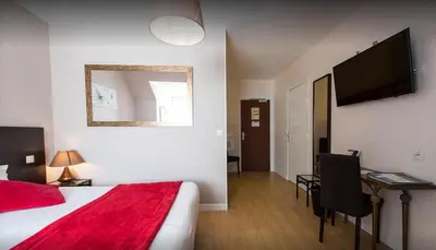 Un ou plusieurs lits dans un hébergement de l'établissement Hôtel Le Bayeux