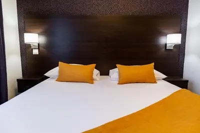 Un ou plusieurs lits dans un hébergement de l'établissement Hotel Astrid Caen centre
