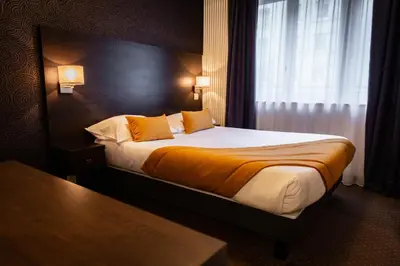 Un ou plusieurs lits dans un hébergement de l'établissement Hotel Astrid Caen centre