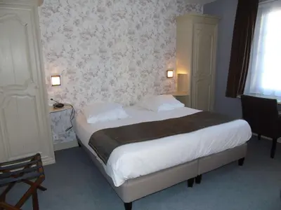 Un ou plusieurs lits dans un hébergement de l'établissement Best Western Hôtel Montgomery