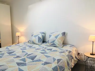 Un ou plusieurs lits dans un hébergement de l'établissement Chaleureux et spacieux appartement de centre-ville - Lit King Size - NETFLIX