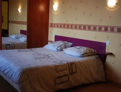 Un ou plusieurs lits dans un hébergement de l'établissement Le Manoir du Butel