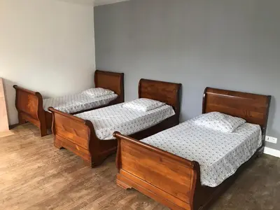 Un ou plusieurs lits dans un hébergement de l'établissement Gîte Manava - grande maison avec jardin en centre ville