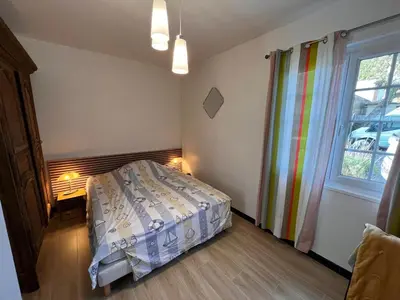 Un ou plusieurs lits dans un hébergement de l'établissement Maison de vacances VUE MER ET CANAL