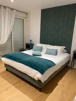 Un ou plusieurs lits dans un hébergement de l'établissement Le Rocher Appart Hôtel