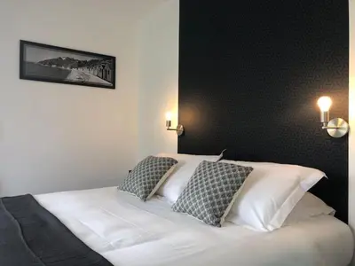 Un ou plusieurs lits dans un hébergement de l'établissement Le Rocher Appart Hôtel