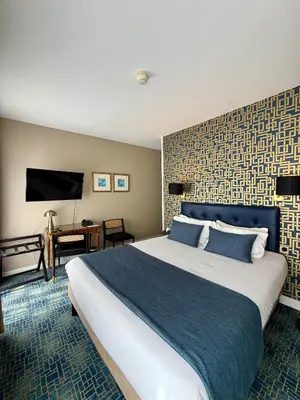 Un ou plusieurs lits dans un hébergement de l'établissement Churchill Hotel Bayeux Centre
