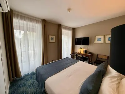 Un ou plusieurs lits dans un hébergement de l'établissement Churchill Hotel Bayeux Centre