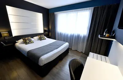 Un ou plusieurs lits dans un hébergement de l'établissement Hôtel Des Quatrans