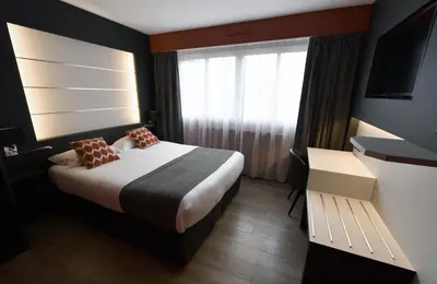 Un ou plusieurs lits dans un hébergement de l'établissement Hôtel Des Quatrans