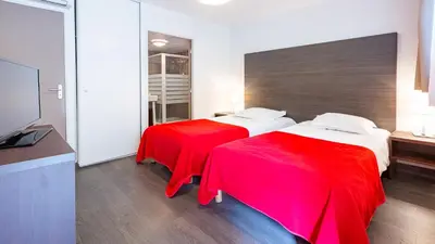 Un ou plusieurs lits dans un hébergement de l'établissement Vacancéole - Les Chambres de la Baie