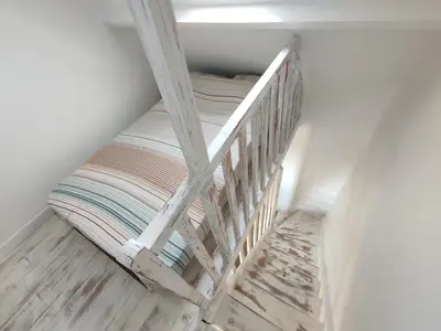 Un ou plusieurs lits dans un hébergement de l'établissement Maison de la plage